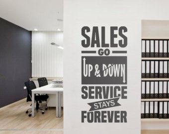 an office with black and white wall decals on the walls that say sales go up & down service stays forever