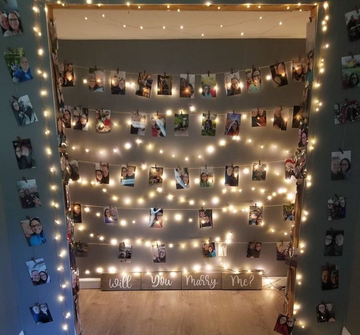 a room with lights and pictures on the wall, all decorated in white string lights