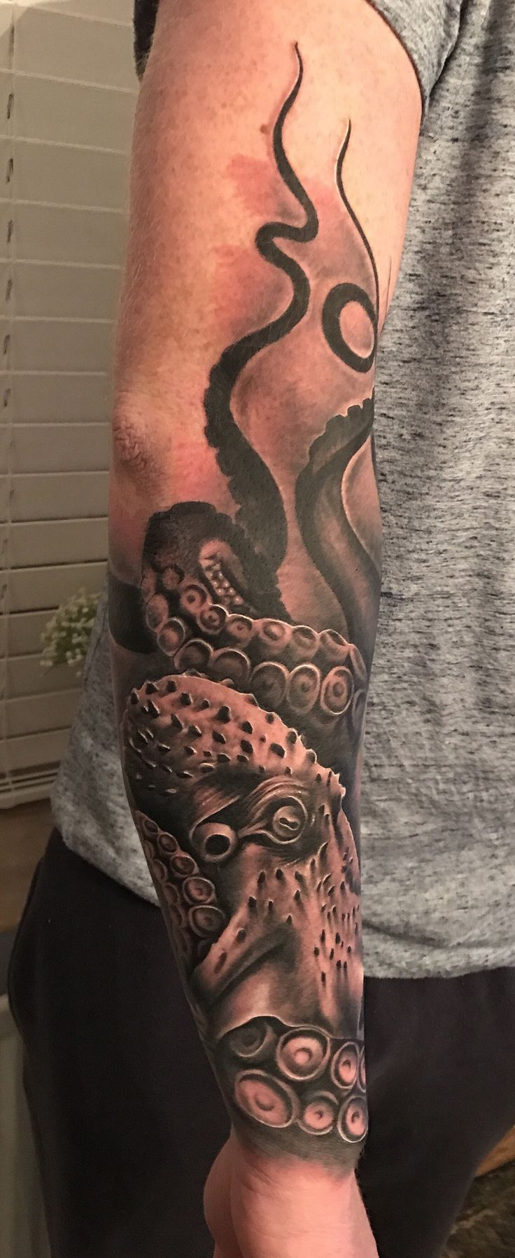 a man with a octopus tattoo on his arm