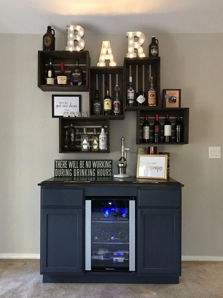 there is a bar with bottles on the shelves and an empty wine bottle in it