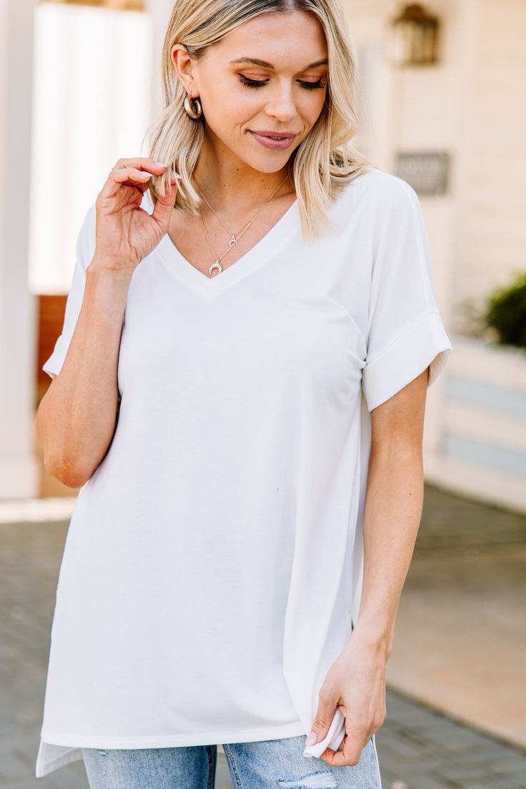 This versatile v-neck tee is here to make your life easy! It's honestly the perfect top for year round styling and layering. You can knot the hem or half tuck into your favorite jeans or shorts. You can layer it with all sorts of jackets, shackets, or kimonos. And don't even get us started on accessories! The options are absolutely endless! This top is truly a staple piece! This top features a v neckline, short cuffed sleeves, and a generous fit. Material has generous amount of stretch. Sydney i White Relaxed Fit V-neck Top, Chic White V-neck T-shirt, White Short Sleeve V-neck Top For Everyday, White V-neck Top For Everyday Spring Wear, White V-neck Top For Everyday Wear, White V-neck Short Sleeve Top, Chic V-neck T-shirt For Everyday, Chic V-neck T-shirt For Layering, Solid V-neck T-shirt For Day Out