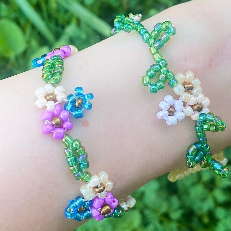 a woman's arm with several bracelets made out of bead and glass beads