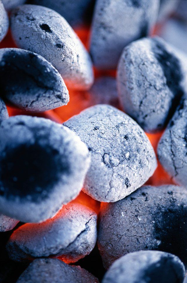 closeup of hot chocolate cookies on an outdoor grill with orange flames in the background