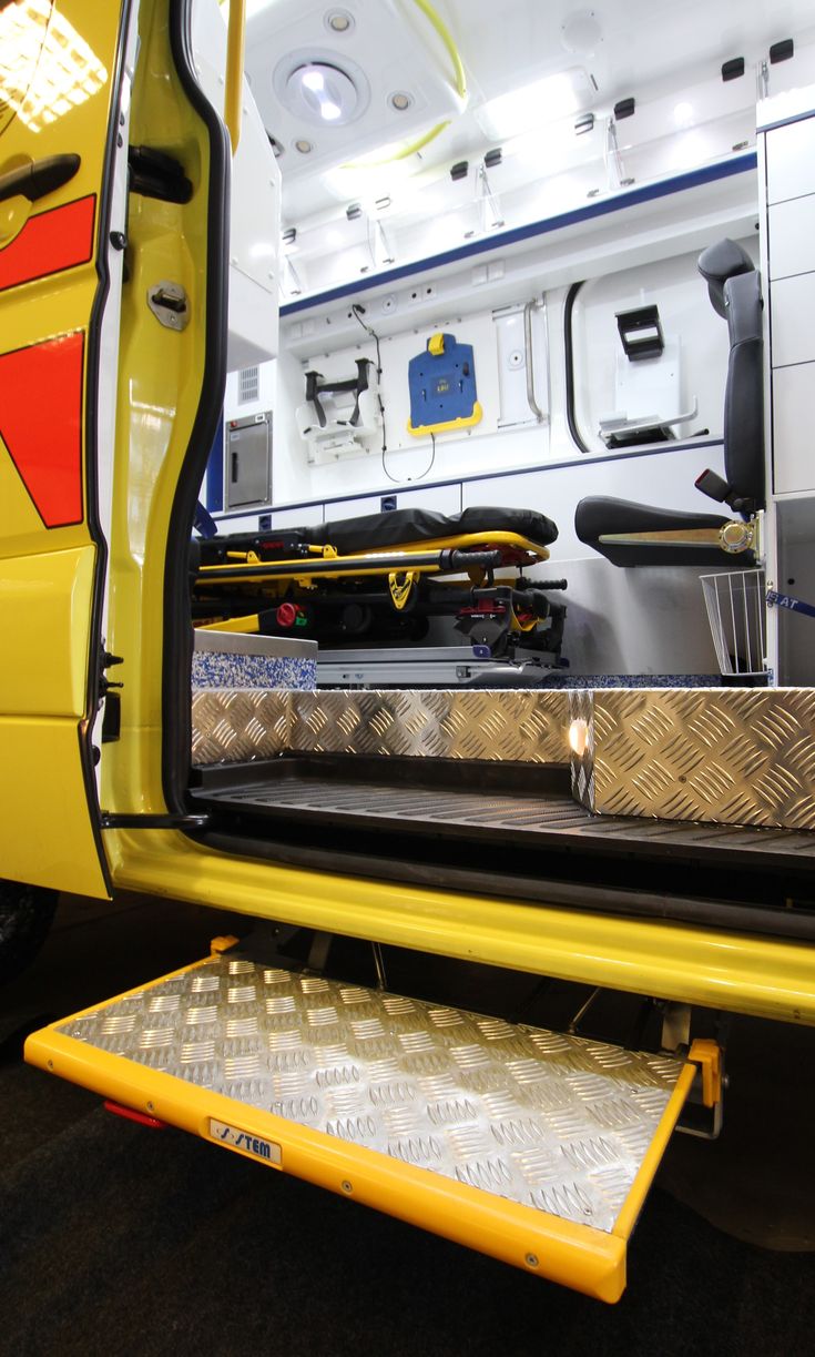 the back end of a yellow van with its door open