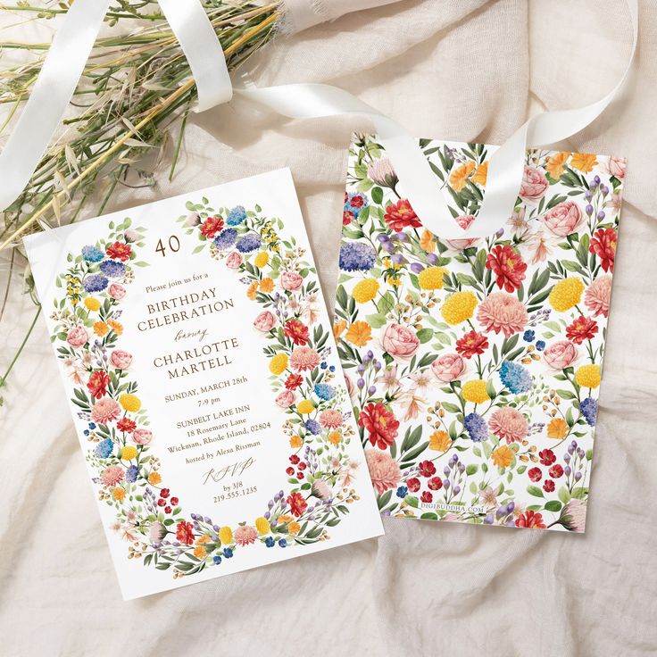 the wedding stationery is laid out on a bed with flowers and ribbons around it