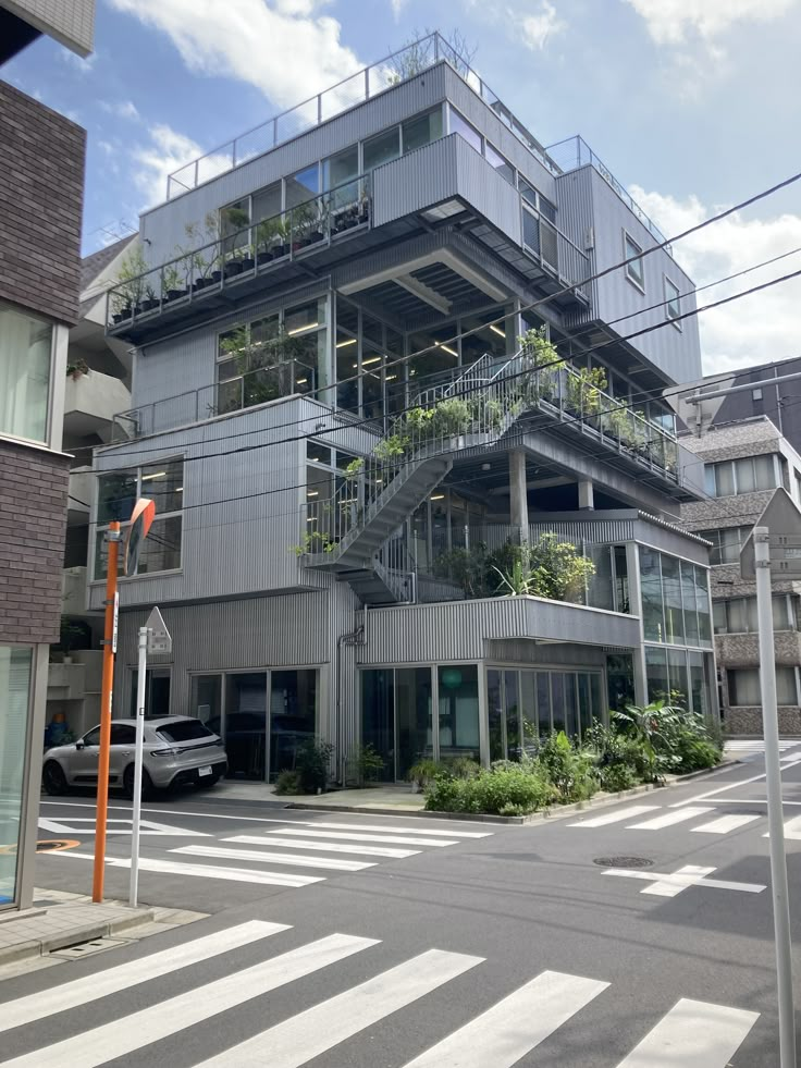 an apartment building with plants growing on the balconies