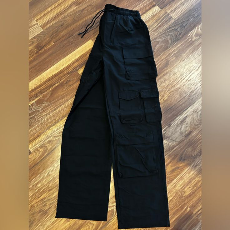 Brand New With Tags Black Utility Style Wide Leg Full Length Pants, Urban High Waist Black Pants, Utility Style Black Wide Leg Full Length Pants, Urban Style High Waist Black Pants, Black Utility Cargo Pants For Fall, Black Cotton Wide Leg Pants With Cargo Pockets, High Waist Black Parachute Pants For Fall, Black Utility Wide Leg Pants With Multiple Pockets, Black Utility Wide Leg Pants With Cargo Pockets