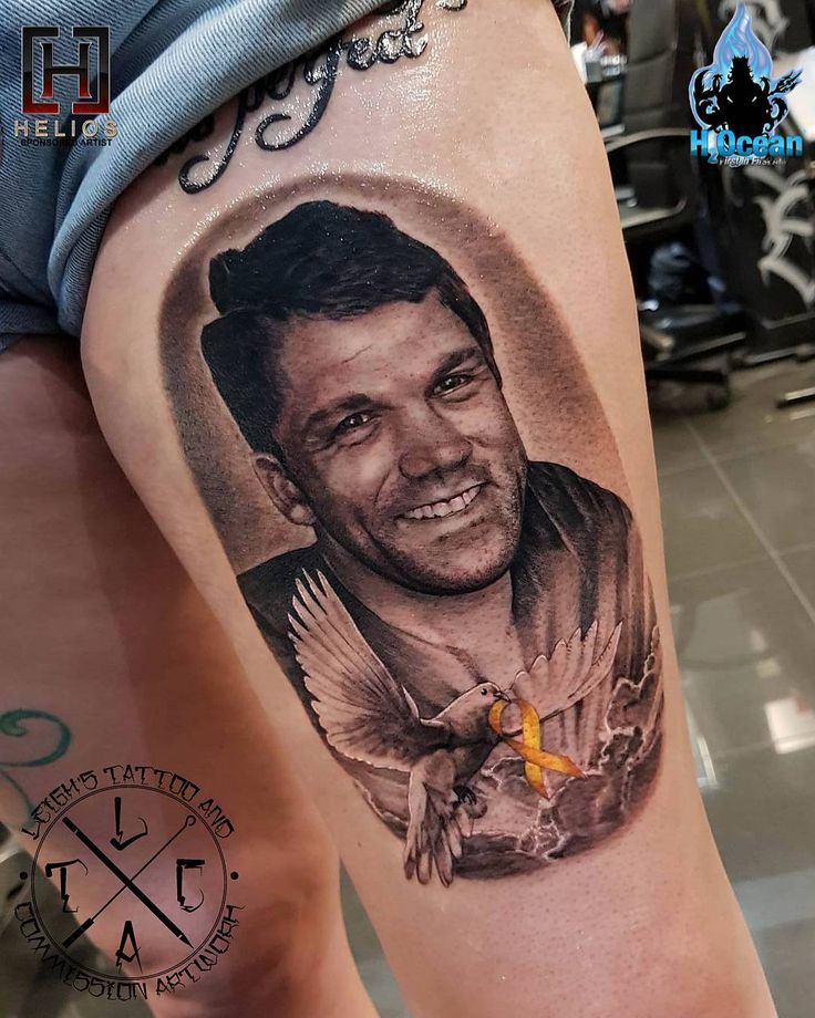 a man's leg with a tattoo on it that has a photo of him