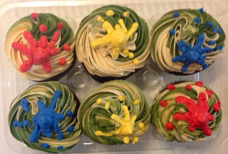 cupcakes decorated with colorful frosting in a plastic container