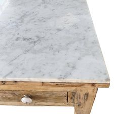 a white marble top coffee table with drawers on one side and an open drawer on the other