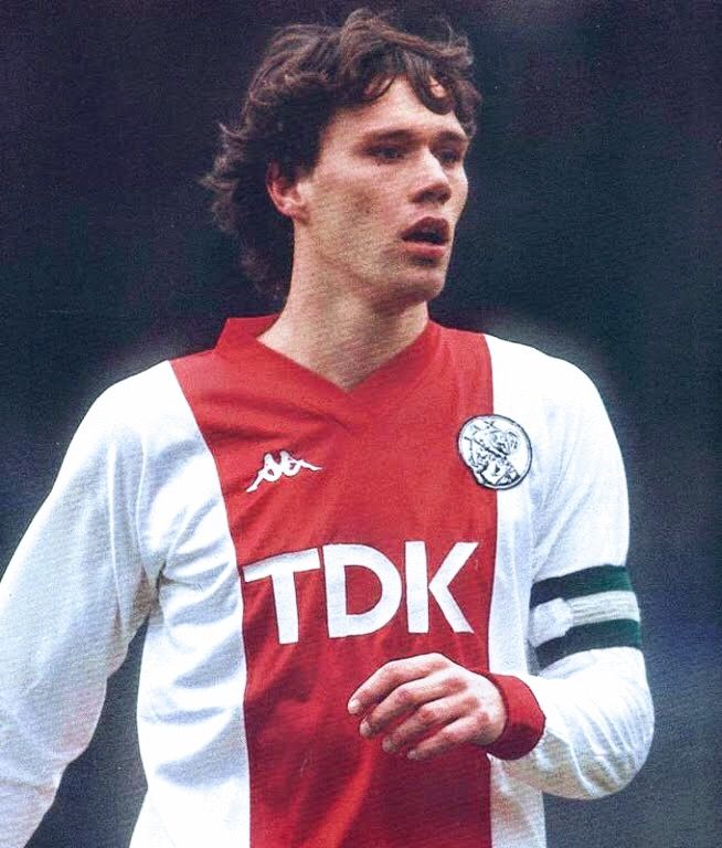 a young man wearing a red and white uniform