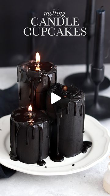 three chocolate candles sitting on top of a white plate