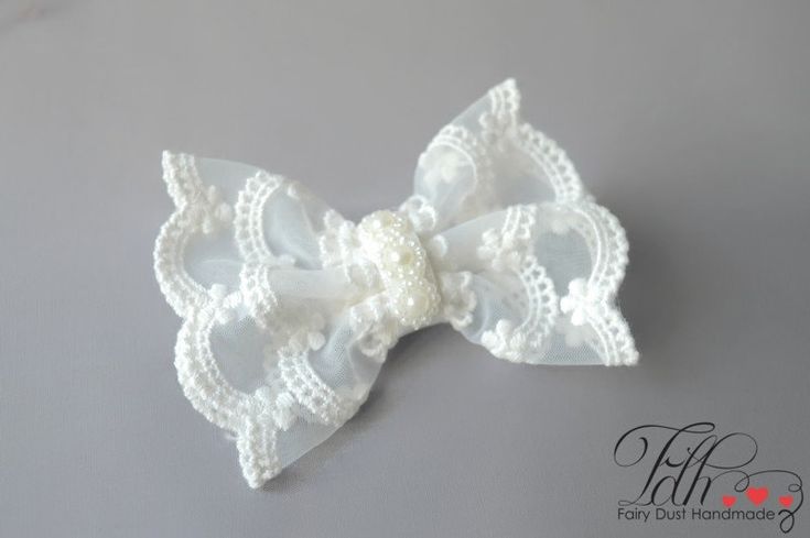 FAIRY DUST HANDMADE Beautiful off white baby bow hair clip. Unique Fairy Dust Headbands design! Handmade in the UK Especially designed for baby girls, newborns, flower girls Making Process: Bow is made from modern style scalloped lace and a satin ribbon, finished with flower pearls. Bow is also finished with felt at the back for comfortable wear. Hair clip looks very elegant on both younger and older girls. Occasion: Perfect for christening, baptism, wedding and any other occasion. Bow measures approximately 3,5 inches. Aligator hair clip is approx. 2,5inches WARNING: Children must be supervised by parents while wearing this hair band due to small parts! Comes from a pet and smoke free studio. Thank you so much for looking:) Cute Ribbon Bow For Wedding, White Ribbon Bow For Gift, White Matching Headband For Baptism, White Hair Accessories With Matching Headband For Baptism, White Bow Hair Accessory For Gift, White Bow Hair Accessories For Gifts, White Bow Tie Hair Accessories As A Gift, White Bow Tie Hair Accessories Gift, White Bow Hair Accessories As Gift