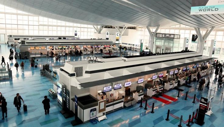 an airport terminal with people walking around