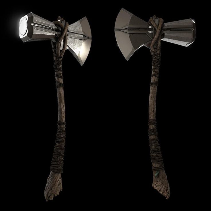 two axes with light shining on them against a black background, one is made from wood and the other has branches