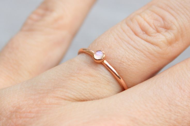 Beautiful birthstone stacking rings. Made in 14k rose gold filled and stone is a 3mm genuine rainbow moonstone. This ring is made to order in your size. If you don't see your size available please feel free to message me. All orders ship in a gift box. If you are ordering multiple items and want them boxed separately, please let me know in the notes at checkout. I ship via USPS. Please review the estimated delivery date and processing times. Processing times vary based on how busy my shop is at Dainty Rose Gold Stackable Rings With Gemstones, Tiny Rose Gold Stackable Rings, Stackable Rose Gold Moonstone Ring For Promise, Stackable Rose Gold Moonstone Promise Ring, Adjustable Dainty Rose Gold Moonstone Ring, Minimalist Rose Gold Moonstone Ring As Gift, Minimalist Rose Gold Stackable Gemstone Rings, Minimalist Rose Gold Stackable Rings With Gemstones, Dainty Rose Gold Moonstone Ring Gift