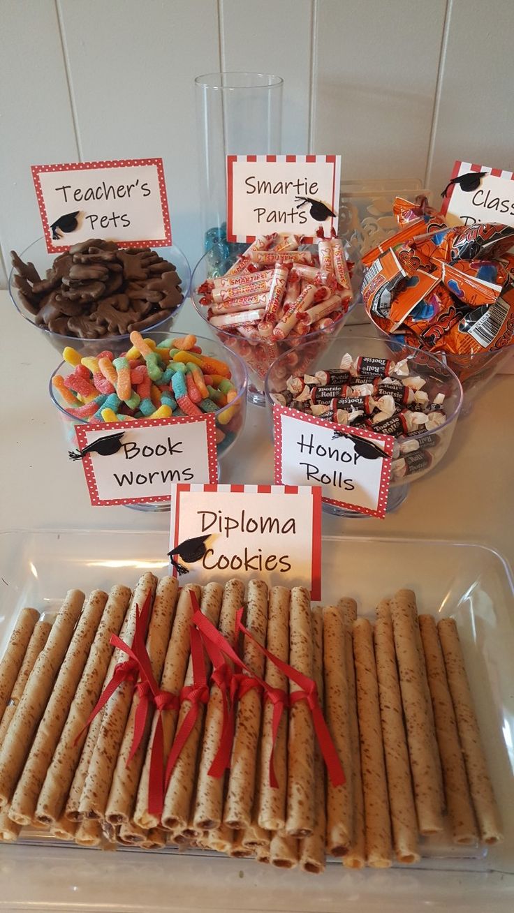 a table topped with lots of different types of candy and crackers next to each other