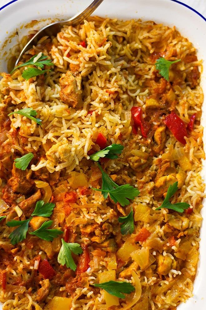 a white bowl filled with rice and vegetables