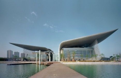 two large buildings sitting on top of a body of water