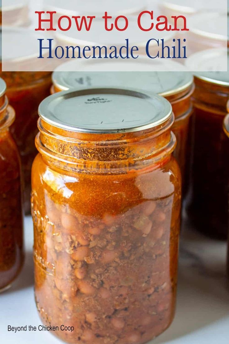 jars filled with homemade chili and beans sitting on a table