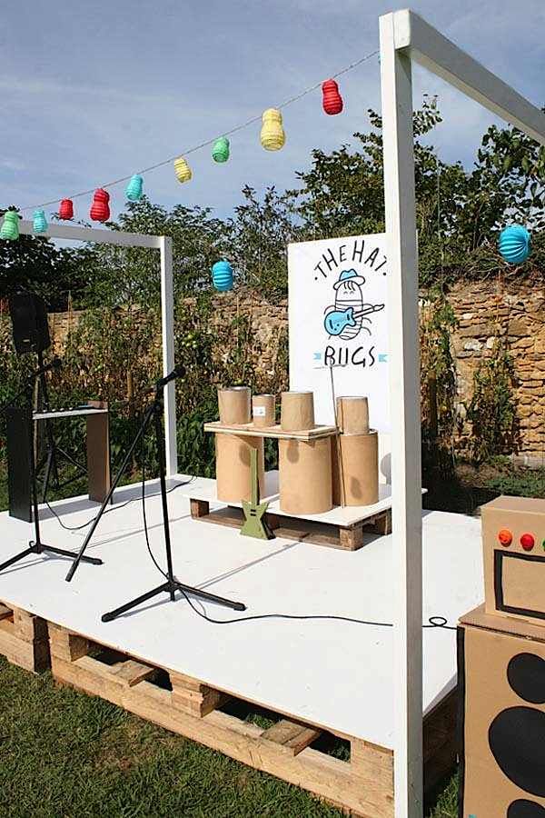 an outdoor stage set up with cardboard boxes and lights