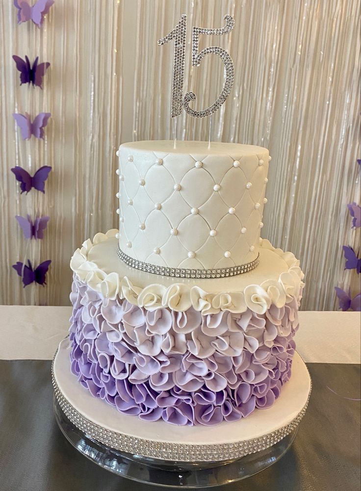 a white and purple cake sitting on top of a table