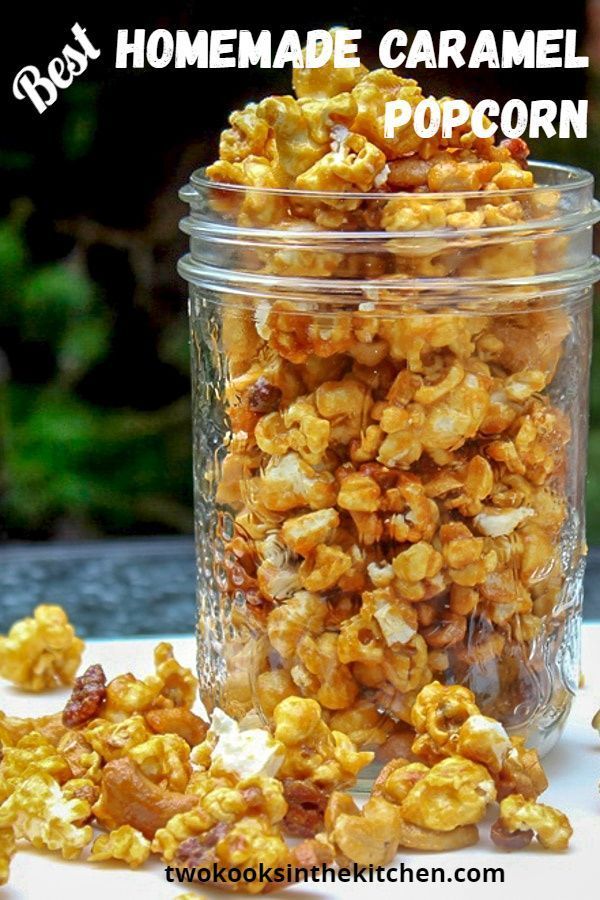 a glass jar filled with popcorn sitting on top of a table