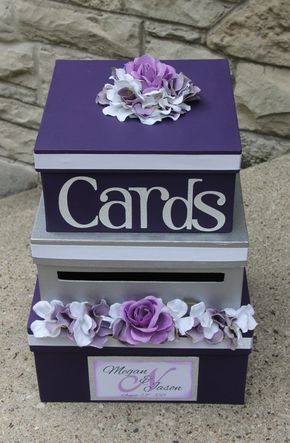 two purple boxes with flowers on them sitting next to each other