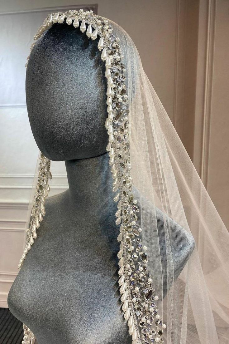 a mannequin wearing a veil with crystal beads