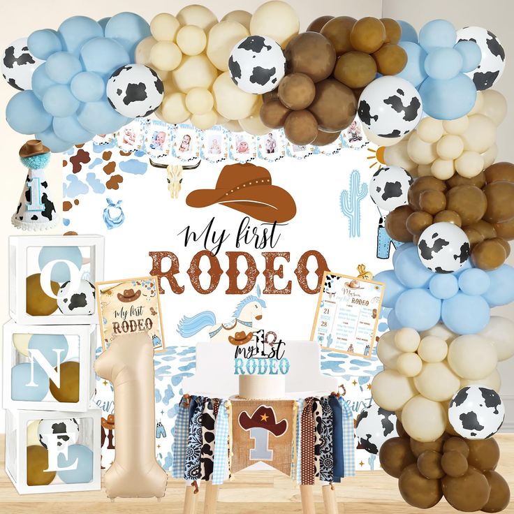 a photo booth with balloons and decorations for rodeo themed birthday party or baby's first birthday