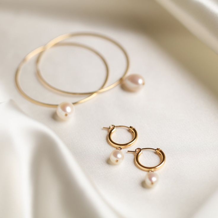 Designer: OFINA An everyday classic. Polished pearl mini hoops to give you a classic modern look. Available in 2 sizes. Small Size: 15mm Hoop w/ 7-8mm Freshwater Pearl Large Size: 18mm Hoop w/ 10mm Freshwater Pearl Material & Care 14k Gold Filled Stone: Freshwater Pearl Hypoallergenic Can be worn in water For more info: Jewelry Care How to Wear Lovely alone or stack the two sizes together. Can also be paired with your favorite huggies and studs! Free Shipping & Repairs within 30 days Classic Pearl Drop Hoop Earrings, Classic Hoop Pearl Drop Earrings, Formal Minimalist Hoop Pearl Earrings, Classic Pearl Hoop Huggie Earrings, Minimalist Hoop Pearl Earrings For Formal Occasions, Classic Pearl Hoop Earrings, Classic Pearl Huggie Earrings Small Hoop, Classic Pearl Small Hoop Huggie Earrings, Classic Pearl Huggie Earrings For Everyday