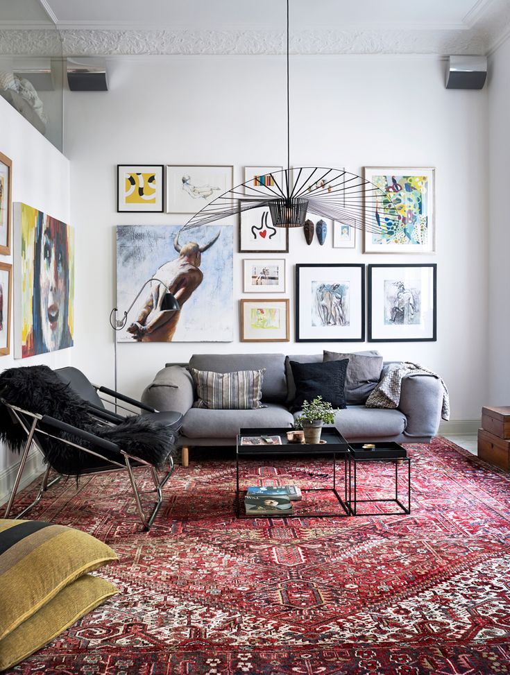 a living room filled with furniture and pictures on the wall above it's couch