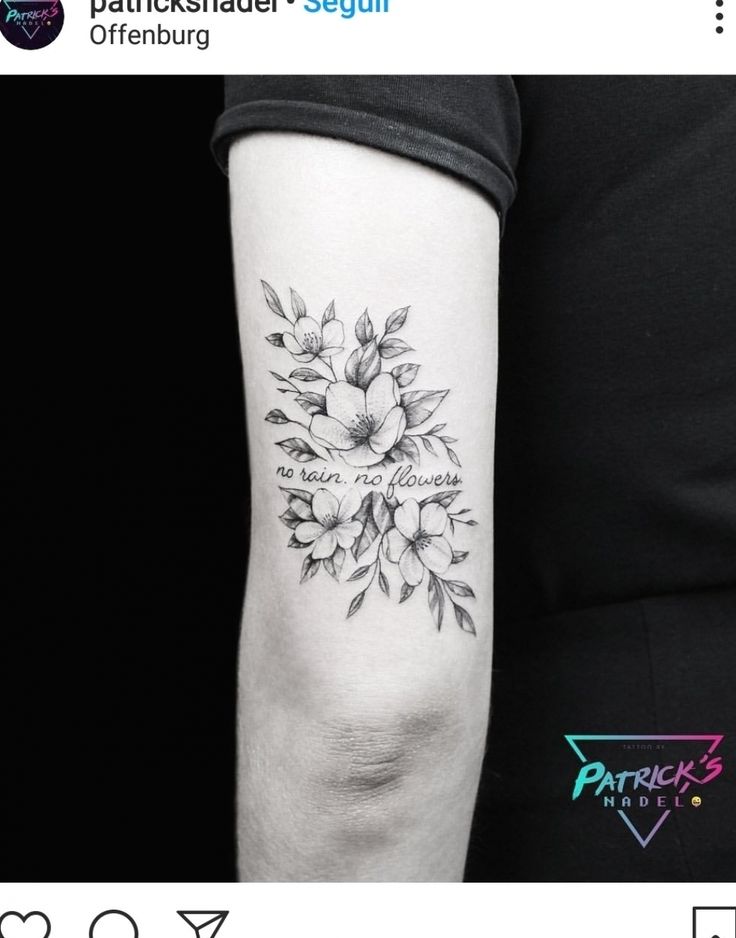 a woman's arm with a flower tattoo on it