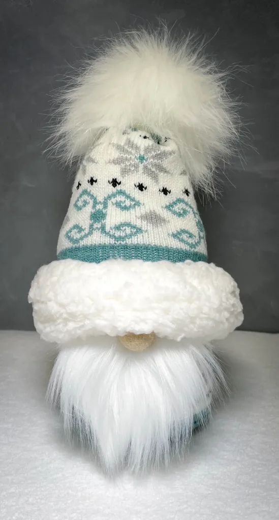 a white and blue knitted hat with fur pom - pom on top