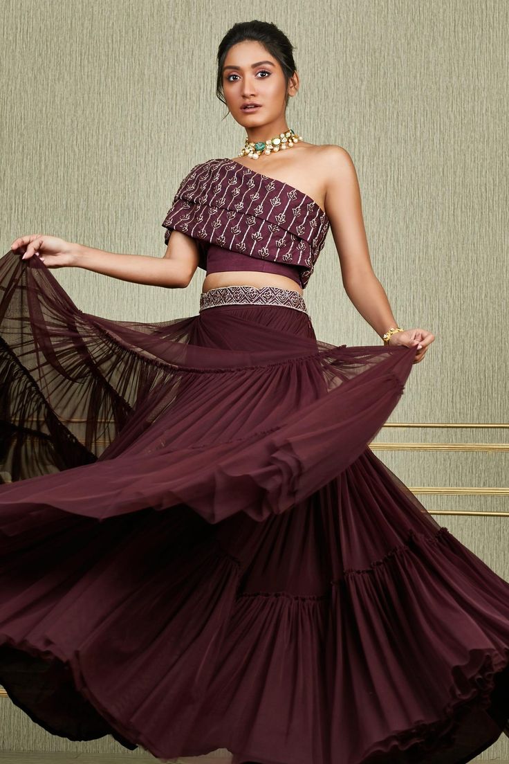 Plum flared lehenga with tiered detail and embroidered waistband. Paired with overlay embroidered one shoulder blouse.
Component: 2
Embroidered
Neckline: Asymmetric
Sleeve Length: Asymmetric
Fabric: Tussar, Net
Color: Maroon
Embroidered sequin, cutdana
Closure:
Lehenga and blouse: Side zip - Aza Fashions Lines Embroidery, Organza Sharara, Purple Lehenga, Embroidered Belt, Choli Designs, Indian Gowns Dresses, Black Saree, Indian Gowns, Designer Party Wear Dresses