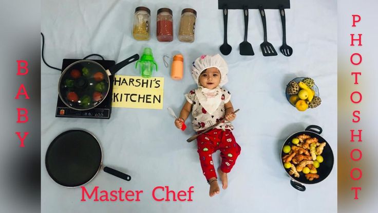 a baby doll laying on top of a table next to cooking utensils and other kitchen items