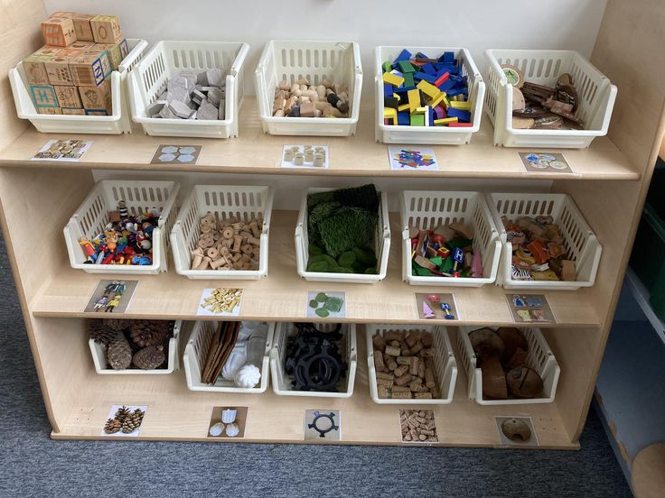 the shelves are filled with different types of toys and materials to play with in their bins