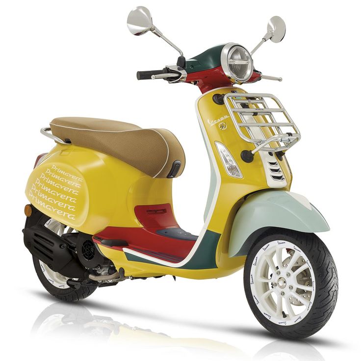 a yellow scooter is parked on a white surface with its seat up and the front wheel down