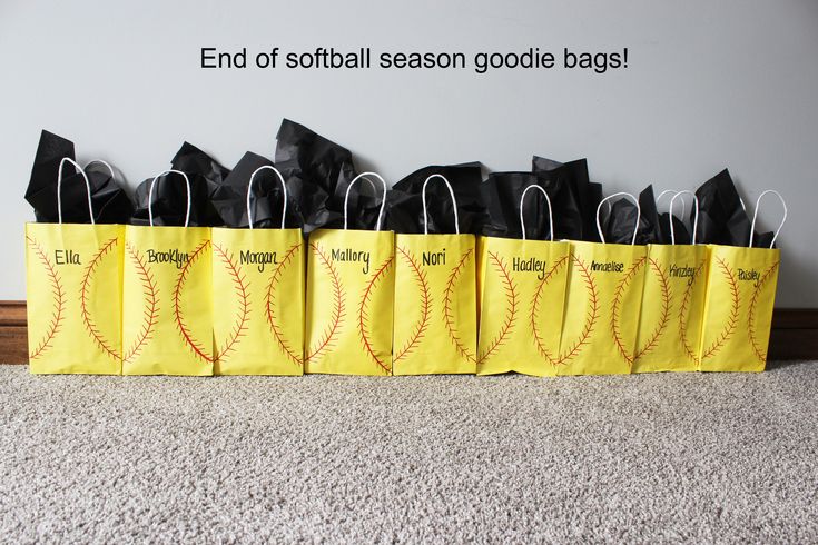 several bags are lined up on the floor in front of a wall that says end of softball season googlele bags