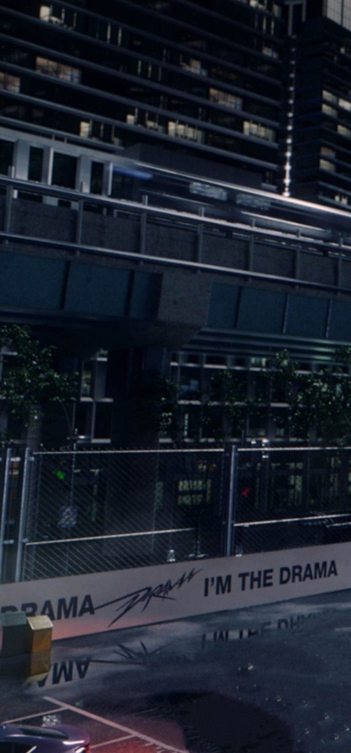 a man riding a skateboard on top of a metal rail in front of a tall building