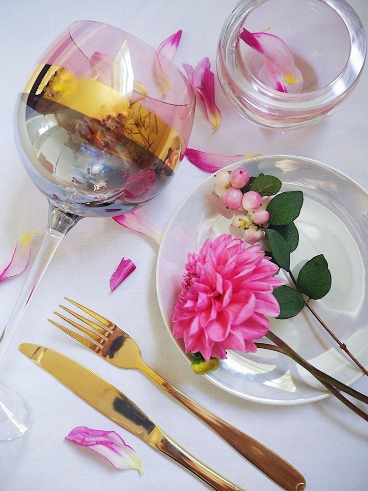 pink flowers and goldware on a white table