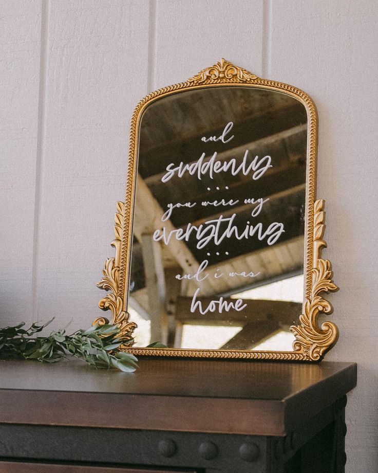 a mirror sitting on top of a wooden table