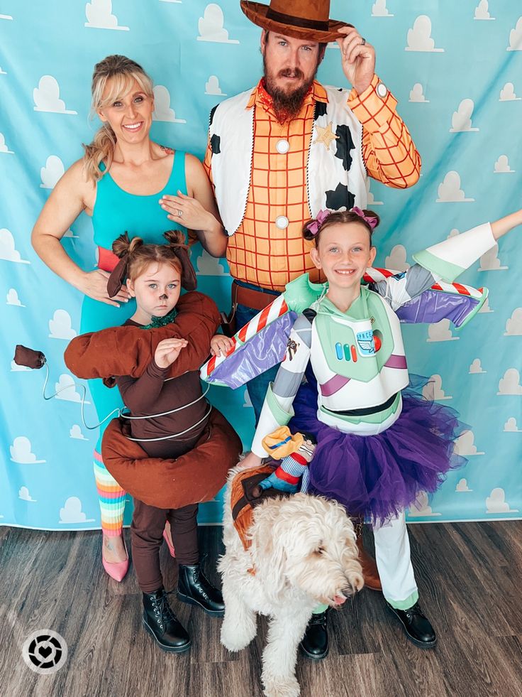 a family dressed up as toy story characters posing for a photo with their pet dog