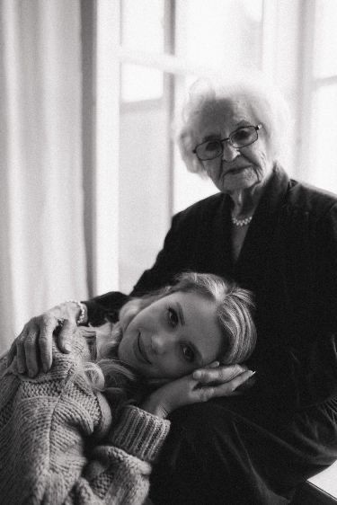 an older woman sitting next to a younger woman