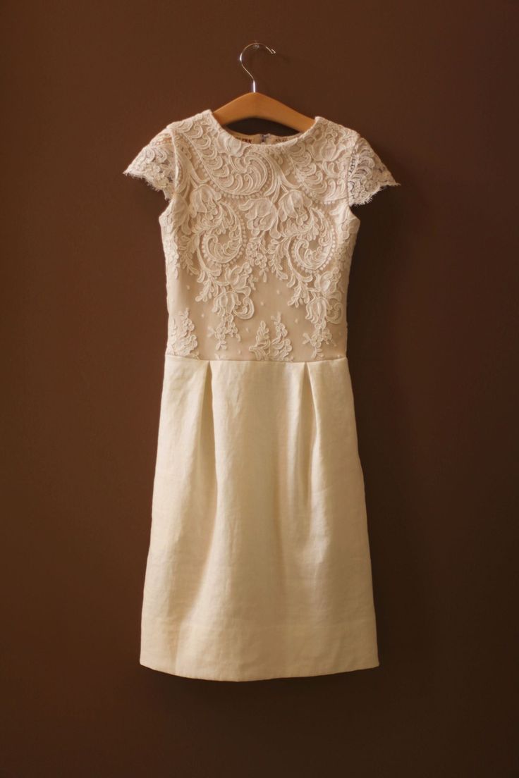 This listing is for the Thommy Dress. The sheath dress is handmade with #5320 ivory French alencon lace with cream lining and ivory linen. the detachable tulle skirt is made with an ivory sash and white, light ivory, and ivory tulle. The Thommy Dress is a shift dress for girls who need to look the part for a wedding, Bat Mitzvah, or First Communion, but who also prefer comfortable, sporty attire. They love its soft knit bodice lining and linen, and the hooks that keep the sash in place without s Fitted Beige Dress With Lace Work, Fitted Beige Lace Work Dress, Fitted Beige Lace Dress With Lace Work, Beige Lace Dress With Fitted Bodice, Fitted Off White Dress With Lace Work, Cream Dresses With Lace Trim And Fitted Bodice, Feminine Fitted Lace Dress With Lace Back, Chic Cream Lace Dress With Scalloped Detail, Fitted Off White Lace Dress With Scalloped Lace