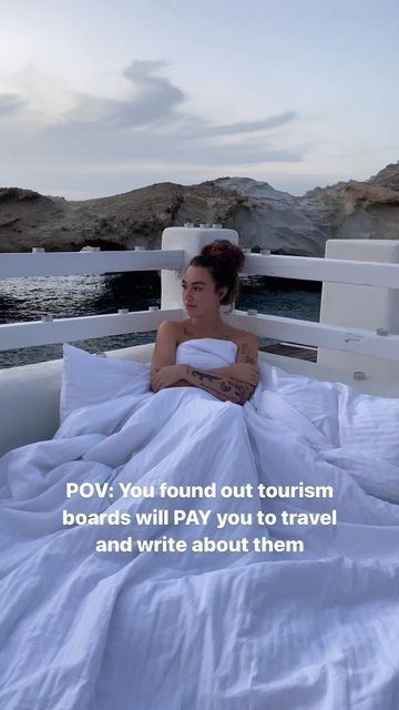 a woman laying in bed on top of a boat with the caption pov you found out tourism boards will pay you to travel and write about them