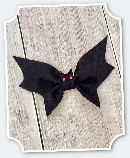 a black bow with red eyes on it