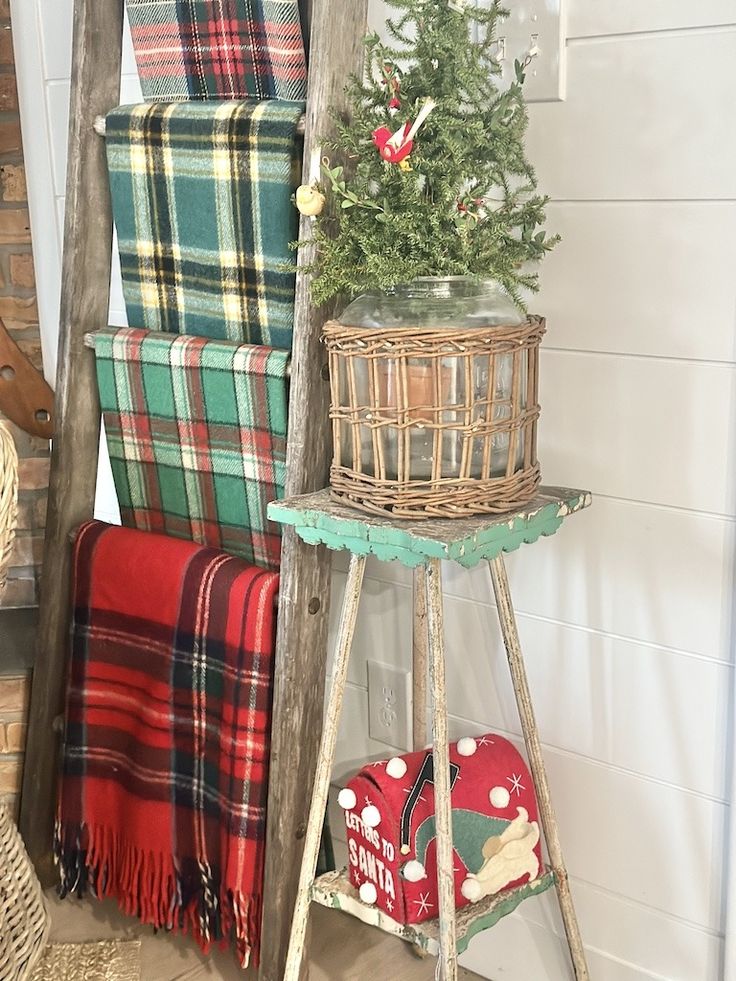 an old ladder is used as a christmas tree stand