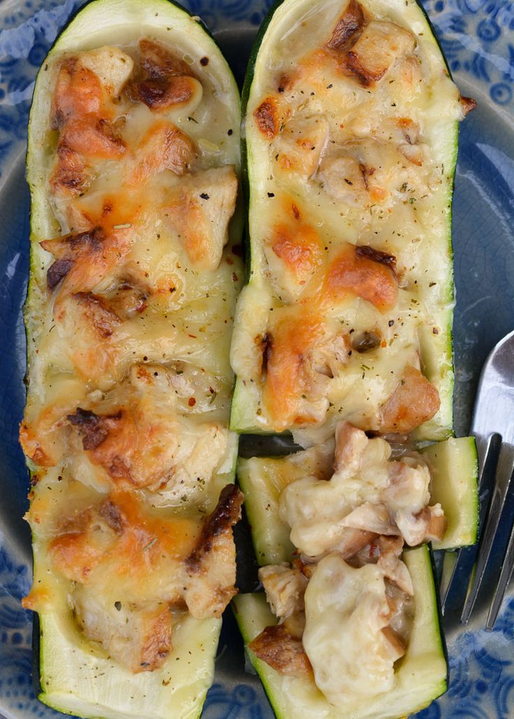 a blue plate topped with zucchini covered in cheese