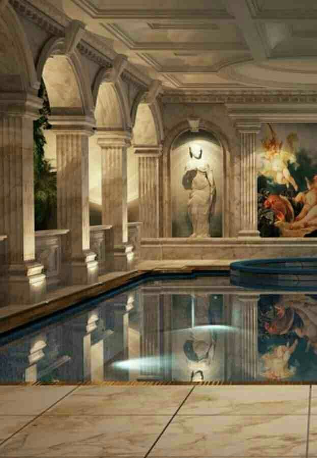 an indoor swimming pool with paintings on the walls